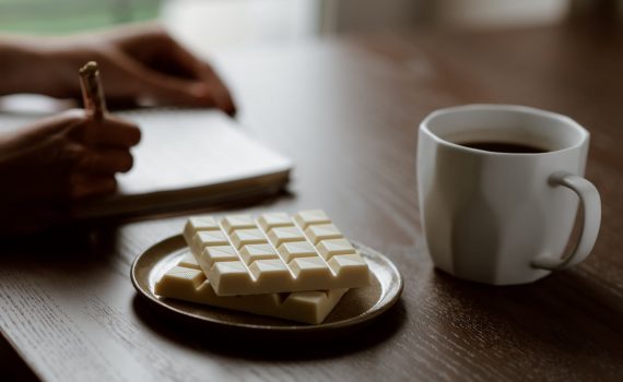 photo of person writing on notepad