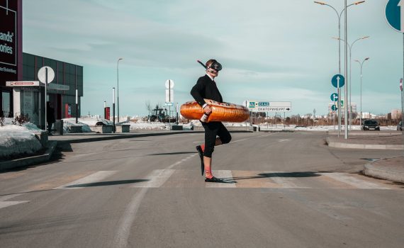 strange man with swimming equipment on street