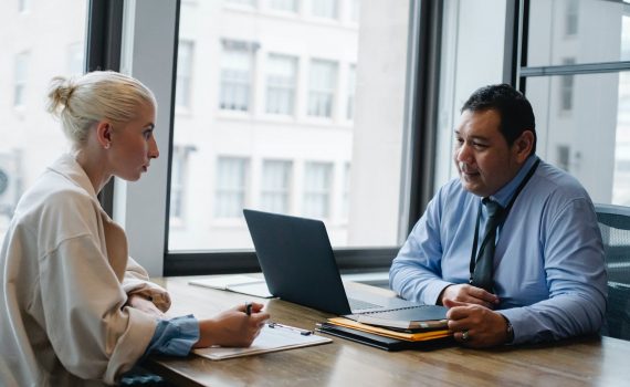 focused ethnic male boss interviewing applicant in office