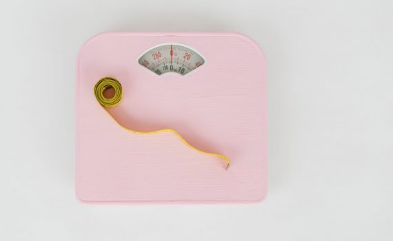 scales and measuring tape on white floor