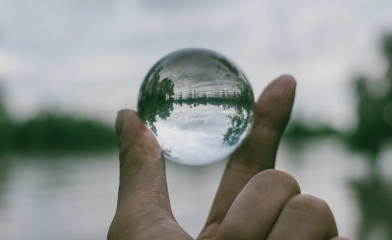 close up photography of person holding crystal ball