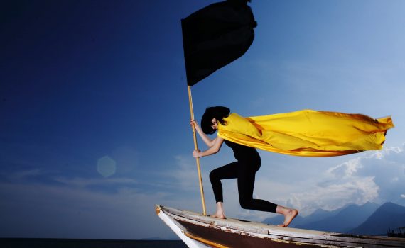 woman holding black flag