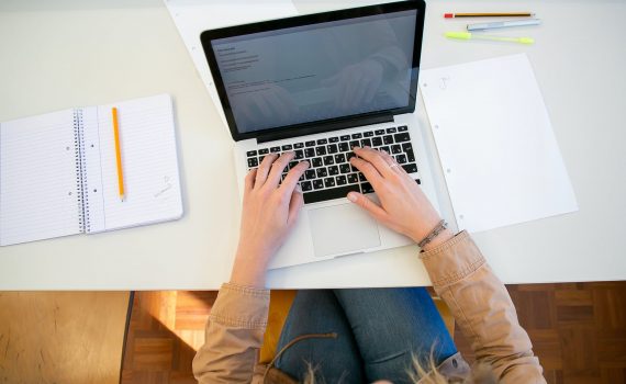 woman working on laptop with documents